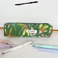 Primer plano del estuche de lona jacquard floral con etiqueta de marca y papelería - Cosmos Fluorescente Verde