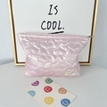 Detailed view of pink heart quilted cosmetic bag with pearl finish and woven logo tag - Big Heart Pink
