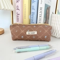 Detailed close-up of brown corduroy pencil case with floral patterns and a yellow zipper - Brown Plaid Bowknot