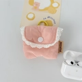 Detail of pink quilted earphone case featuring white lace edges and a yellow metal hook - Small / Quilted Flower Pink