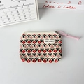 Close-up of floral storage bag with zipper and pink cord on a white background - Corduroy Red Small Flower