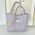 Detail view of purple quilted handbag with cute rabbit and bear patterns and soft handles - Blue Base Dessert Bear