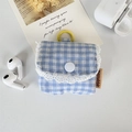 Close-up of blue plaid fabric earphone case with white lace trim and yellow hanging ring - Small Blue Grid