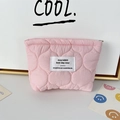 Detail of pink quilted lipstick pouch showing soft fabric texture and woven label - Quilted Gourd Pink