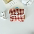 Detail of red checkered earphone case with white lace trim and blue silicone ring - Small Red Plaid