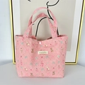 Detail of pink quilted tote bag featuring cute animal prints and secure snap closure - Pink Base Dessert Bear