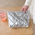 Silver quilted PU makeup bag with metallic finish and brand label on wooden table - Bubble Rhombus Silver