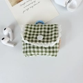 Detail of green plaid earphone case with white lace trim and blue hanging hook - Small Green Grid