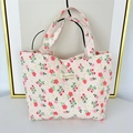 Detail of floral quilted lunch bag showing strawberry print and snap button closure - Light Pink Flower