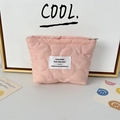 Close-up of pink quilted cosmetic bag showing soft cloud stitching and silver zipper - Quilted Flower Pink