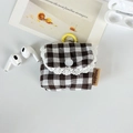 Detail of plaid earphone case with delicate lace edge and a yellow hanging hook - Large Brown Grid
