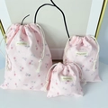 Three-piece set of pink floral drawstring storage bags in various sizes with textured fabric - Large / Pink Floral