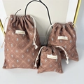 Detailed view of three-piece brown checkered cotton storage bags with drawstring - Large / Brown Plaid Bowknot
