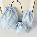 Detailed view of light blue checkered drawstring storage bags with floral patterns - Large / Blue Plaid Bow