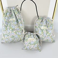 Detailed set of three floral drawstring storage bags in various sizes with purple flowers - Large / Green Floral