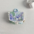 Detail of floral purple earphone case with white lace trim and plastic clip attachment - Violet