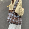 Fashionable retro plaid tote bag with brown embroidery shown on model for autumn style - Blue Large Plaid