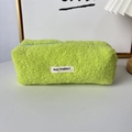 Detailed close-up of a neon green teddy plush pencil case with a blue zipper and woven label - Green