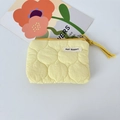 Detailed view of yellow quilted pouch featuring wave stitching and a woven lanyard cord - Quilted Gourd Yellow