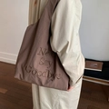 Brown nylon tote bag with 'Never Say Goodbye' embroidery on a shoulder-carried model - Brown