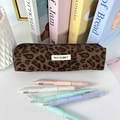 Close-up of leopard print corduroy pencil case with pastel pens on a desk - Green Large Leopard