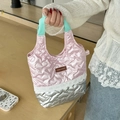 Close-up of quilted heart texture with lace trim on a pink and silver handbag - Pink & Silver Heart Patchwork