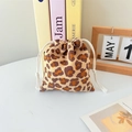 Detail view of leopard print corduroy drawstring pouch with white woven rope closure - Yellow Large Leopard