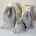 Three sizes of grey corduroy drawstring pouches with striped texture for storage - Small / Gray