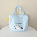 Detail of light blue tote bag featuring plush rabbit embroidery and yellow webbing accent - Blue Flop Rabbit