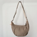 Macro view of brown corduroy crossbody bag showing fine ribbed texture and zipper detail - Khaki