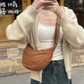 Mirror selfie showing a brown corduroy crescent crossbody bag with adjustable strap - Brown