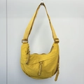Close-up of vibrant yellow nylon dumpling bag featuring durable zippers and woven pullers - Ginger Yellow (Small)