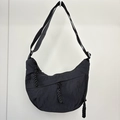Detail of black nylon dumpling bag featuring durable woven zipper pulls and adjustable strap - Black (Small Size)
