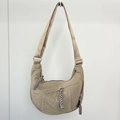 Detail of beige nylon dumpling bag featuring unique long woven zipper pullers on wall - Khaki (Small)
