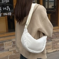 Back view of a model wearing a white corduroy crescent moon crossbody bag in a warm setting - White