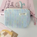 Close-up of woven tweed coin purse with MAY RABBIT label and pink rope zipper puller - Blue