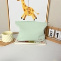 Close-up of light green waffle fabric makeup bag with metal zipper and logo label - Green