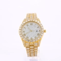 Macro view of gold iced-out watch with crystal bezel, roman numerals, and date window - Gold