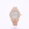 Detail of rose gold iced-out watch showing Roman numerals and a date window - Rose Gold