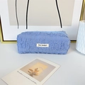 Detailed view of sky blue pleated fabric pencil case with May Rabbit woven label - Blue