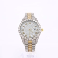 Close-up of luxury iced-out watch with silver and gold steel band and calendar window - Gold & Silver