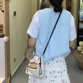 White canvas bucket bag featuring bakery embroidery and striped strap worn by a model - Bread (Grey)