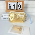 Close-up of golden metallic cosmetic bag with crinkled texture and sky blue woven lanyard - Gold
