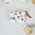 Detail of floral quilted coin purse with purple flower pattern and zipper puller - Ink Floral