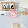 Detail of pink drawstring bag with heart patterns and May Rabbit logo label - Small