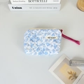 Detail of floral quilted mini pouch with May Rabbit label and pink drawstring cord - Blue Floral