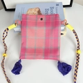 Detailed shot of vintage plaid crossbody mini bag with purple tassels and woven strap - Rose Pink Plaid Mini Crossbody Bag