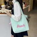 Detail of mint green nylon tote bag featuring pink Beach print on a lifestyle background - Beach Mint Green