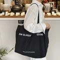 Minimalist black large capacity canvas tote bag with white lettering for daily commute - Black
