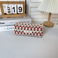 Detail of vintage floral corduroy pencil case with May Rabbit woven label on a cozy desk - Corduroy Red Small Flower